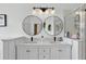 Bright bathroom features double sinks, modern lighting, and a glass-enclosed shower at 2612 Keswick Ct, Kissimmee, FL 34744