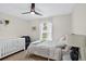 Comfortable bedroom featuring crib, ceiling fan, natural light and neutral colors at 2612 Keswick Ct, Kissimmee, FL 34744