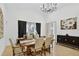 Bright dining room with vaulted ceilings, chandelier, and large window with stylish black and white curtains at 2612 Keswick Ct, Kissimmee, FL 34744