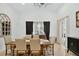 Elegant dining room features a wooden table, upholstered chairs, modern chandelier, and sliding glass door at 2612 Keswick Ct, Kissimmee, FL 34744