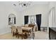 Dining room with a wood table, beige upholstered chairs, and ample natural light at 2612 Keswick Ct, Kissimmee, FL 34744