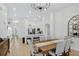 Bright dining area features a wood table, chandelier and flows into the entryway and open kitchen at 2612 Keswick Ct, Kissimmee, FL 34744