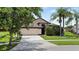 Well-maintained home exterior with a driveway and lush landscaping at 2612 Keswick Ct, Kissimmee, FL 34744