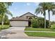 Charming single-story home featuring a two-car garage, landscaped yard, and mature trees at 2612 Keswick Ct, Kissimmee, FL 34744
