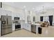 Bright kitchen boasts stainless steel appliances, white cabinetry and an island overlooking the dining area at 2612 Keswick Ct, Kissimmee, FL 34744
