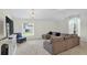 Spacious living room boasts vaulted ceilings, a large sectional, and a window offering pleasant views of the outdoors at 2612 Keswick Ct, Kissimmee, FL 34744
