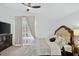 Cozy bedroom features a plush queen bed, dark wood furniture, and sliding glass door to the outdoor pool at 2612 Keswick Ct, Kissimmee, FL 34744