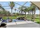 Enjoy this screened patio with views of the lake and palm trees at 2612 Keswick Ct, Kissimmee, FL 34744