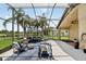 Screened patio with outdoor seating area, string lights, and views of the lake at 2612 Keswick Ct, Kissimmee, FL 34744