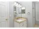 Bathroom featuring vanity with granite top, large mirror, tile floors, and contemporary lighting at 267 Goldenrain Dr # 30, Celebration, FL 34747