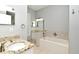 Bathroom featuring vanity with granite top, large mirror, tile floors, and a bathtub at 267 Goldenrain Dr # 30, Celebration, FL 34747