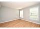Bedroom with wood-look flooring, light walls, and natural light from two windows at 267 Goldenrain Dr # 30, Celebration, FL 34747