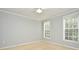 Bright bedroom features neutral carpet, two windows for natural light and painted walls at 267 Goldenrain Dr # 30, Celebration, FL 34747
