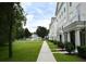 Exterior community view showcasing well-manicured green spaces, sidewalks, and building exteriors at 267 Goldenrain Dr # 30, Celebration, FL 34747
