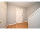 Foyer featuring wood-look flooring, a white front door, and staircase access at 267 Goldenrain Dr # 30, Celebration, FL 34747