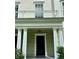 Inviting front entrance featuring stately white columns, a balcony, and dark-colored front door at 267 Goldenrain Dr # 30, Celebration, FL 34747