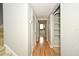 Hallway with hard surface floors and an alcove with shelving, leading to the staircase at 267 Goldenrain Dr # 30, Celebration, FL 34747