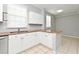 Kitchen featuring white cabinetry, granite countertops, stainless steel appliances, and tile floors at 267 Goldenrain Dr # 30, Celebration, FL 34747