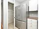 Well-equipped kitchen with stainless steel refrigerator and pantry with wire shelving at 267 Goldenrain Dr # 30, Celebration, FL 34747