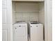Laundry closet showcasing a side-by-side washer and dryer and wire shelving at 267 Goldenrain Dr # 30, Celebration, FL 34747