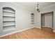 Versatile living room with hard surface flooring, built-in shelving, and stylish chandelier at 267 Goldenrain Dr # 30, Celebration, FL 34747