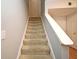 Carpeted stairway with neutral walls and white trim leads to the next level of the home at 267 Goldenrain Dr # 30, Celebration, FL 34747