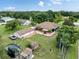 Expansive property featuring a home, detached garage, pool, garden, and trampoline, all set amidst lush landscaping at 2695 Hilliard Ct, Kissimmee, FL 34744