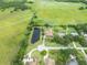 High angle showcasing home with pond, expansive green space, and mature trees, offering a serene, private setting at 2695 Hilliard Ct, Kissimmee, FL 34744