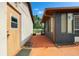 Rear view showcasing an outdoor patio area with views of the yard and adjacent garden area at 2695 Hilliard Ct, Kissimmee, FL 34744