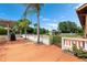 A beautiful backyard featuring palm trees, a patio, a white fence, and an above-ground pool in a well-maintained lawn at 2695 Hilliard Ct, Kissimmee, FL 34744