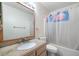 Clean bathroom featuring a shower with tub, toilet and single sink vanity at 2695 Hilliard Ct, Kissimmee, FL 34744