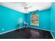Bright bedroom with wood floors, a ceiling fan, and a large window providing ample natural light at 2695 Hilliard Ct, Kissimmee, FL 34744