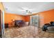 Spacious bedroom with tile floors, ceiling fan, French doors, and accent wall at 2695 Hilliard Ct, Kissimmee, FL 34744