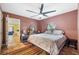 Bedroom with mauve walls, terracotta tile flooring, and neutral furniture, next to an adjoining space at 2695 Hilliard Ct, Kissimmee, FL 34744