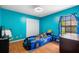 Vibrant bedroom featuring a racecar bed, wood floors, and ample natural light from the window at 2695 Hilliard Ct, Kissimmee, FL 34744