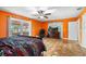 Bright bedroom featuring terracotta tile flooring, a ceiling fan, and sliding glass doors to the backyard at 2695 Hilliard Ct, Kissimmee, FL 34744