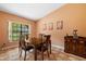 Cozy dining room with warm colors, tile floor, wooden furniture, and bright natural light coming in from window at 2695 Hilliard Ct, Kissimmee, FL 34744