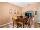 The dining room has a wooden table set with chairs, tile floors, and view to the kitchen on an angle at 2695 Hilliard Ct, Kissimmee, FL 34744