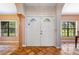 Elegant foyer features a double door, decorative tile flooring, arched entries, and windows offering bright natural light at 2695 Hilliard Ct, Kissimmee, FL 34744