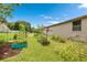 Backyard garden area featuring raised garden beds, lush greenery, and a spacious outdoor space at 2695 Hilliard Ct, Kissimmee, FL 34744