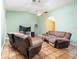 Bright living room with tile floors, ceiling fan, and neutral color scheme, offering a comfortable gathering space at 2695 Hilliard Ct, Kissimmee, FL 34744