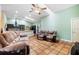 Open living room showcases tile flooring, ceiling fan, and seamless flow into the kitchen at 2695 Hilliard Ct, Kissimmee, FL 34744