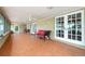 Enclosed patio with tile flooring, offering plenty of space, seating and access to the backyard at 2695 Hilliard Ct, Kissimmee, FL 34744