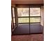 Enclosed carpeted balcony overlooking lush greenery, creating a peaceful retreat and enhancing the appeal of the home at 3036 S Semoran Blvd # S, Orlando, FL 32822