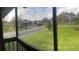 A balcony view of a grassy area and condominium buildings at 3036 S Semoran Blvd # S, Orlando, FL 32822
