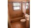 Neutral bathroom features a bathtub, a window and tiled walls at 3036 S Semoran Blvd # S, Orlando, FL 32822