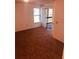 View of carpeted bedroom with a sliding glass door to the balcony at 3036 S Semoran Blvd # S, Orlando, FL 32822