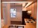 Functional kitchen with wooden cabinets and laminated countertops, appliances including a black refrigerator and an electric stove at 3036 S Semoran Blvd # S, Orlando, FL 32822