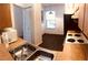 Functional kitchen featuring wooden cabinets, laminated countertops, and a stainless steel sink with modern faucet fixtures at 3036 S Semoran Blvd # S, Orlando, FL 32822