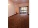 Spacious carpeted living room with natural light and access to a balcony, perfect for relaxing or entertaining guests at 3036 S Semoran Blvd # S, Orlando, FL 32822